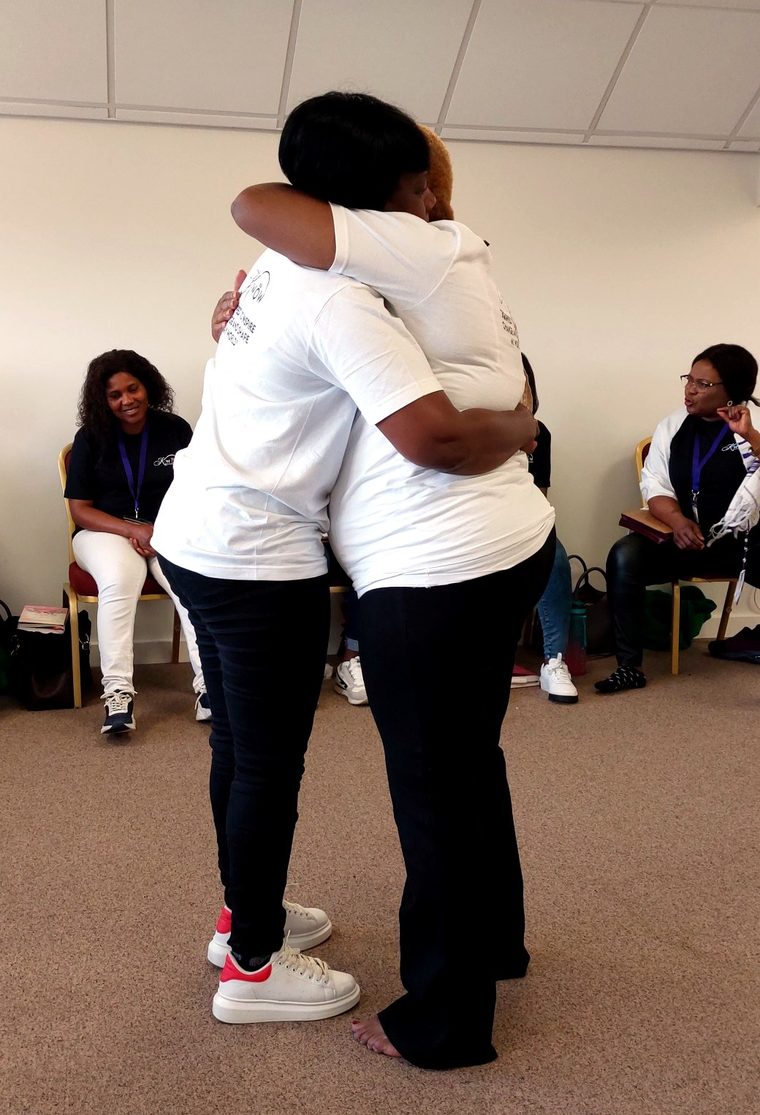 Two women embracing during a ministry moment